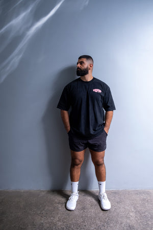 Man wearing a black fit size flex appeal t-shirt and shorts