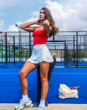 Model playing tennis in ace flare tennis skirt – verveactivewear.com