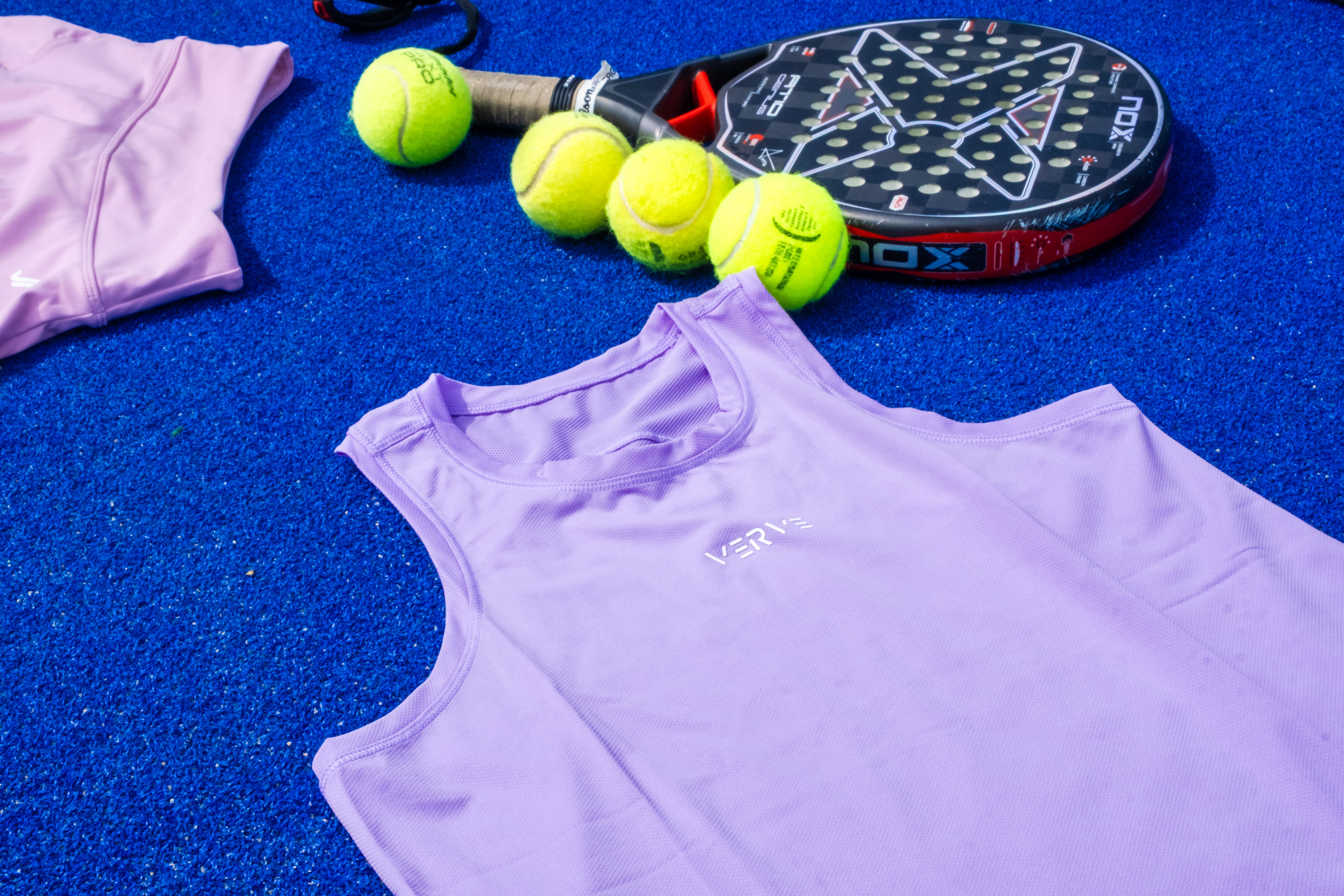 Up close Verve purple ultra light tank top on a tennis court 
