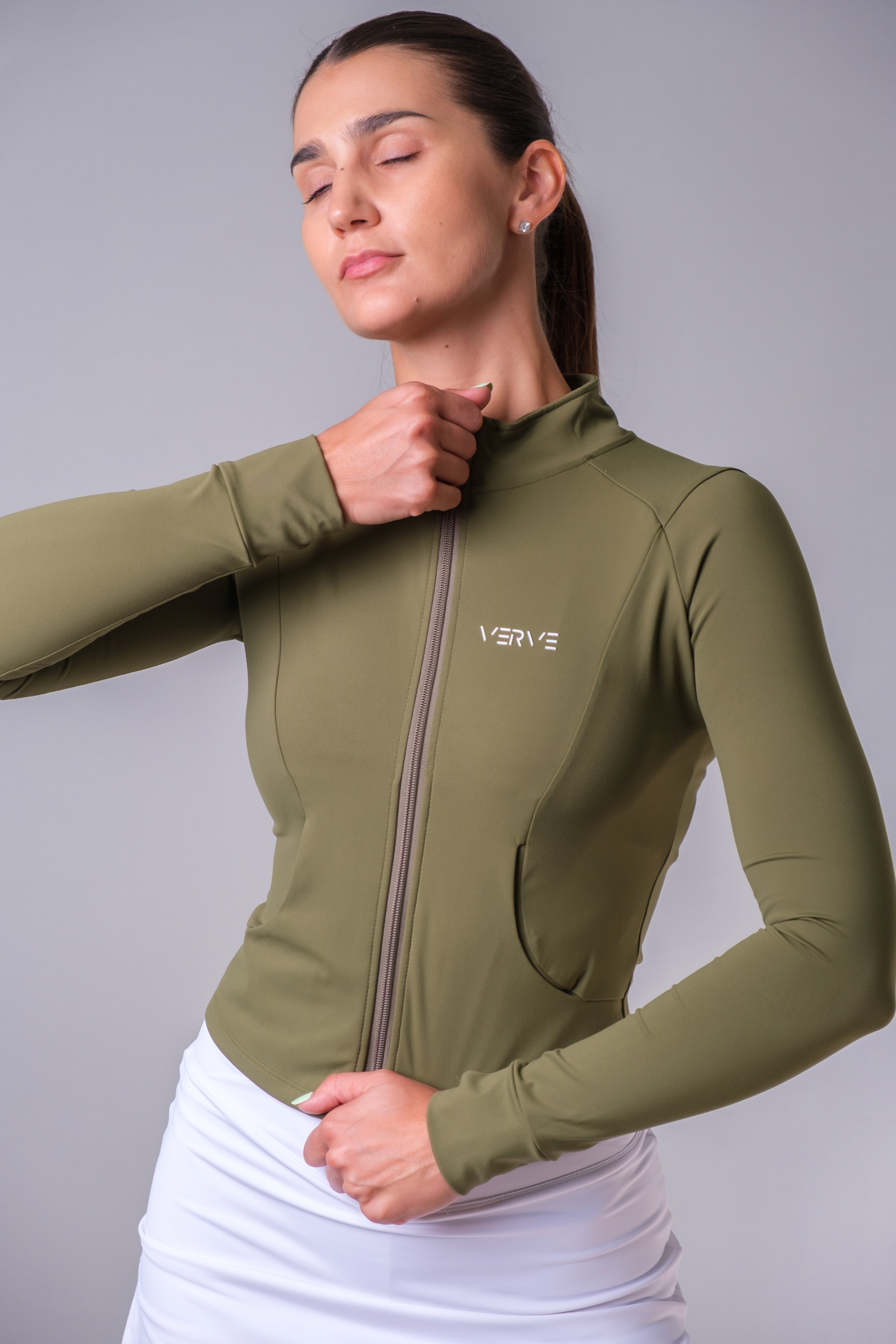 Close-up front view of Form Zip-Up Jacket in olive green with zip closure and side pockets – verveactivewear.com

